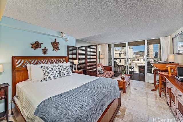 445 Seaside Ave Unit 1618, Honolulu, HI 96815 - bedroom featuring a textured ceiling, a city view, and access to exterior