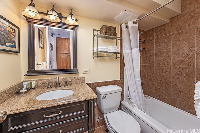 445 Seaside Ave Unit 1618, Honolulu, HI 96815 - bathroom with vanity, shower / bath combo, toilet, tile walls, and wainscoting