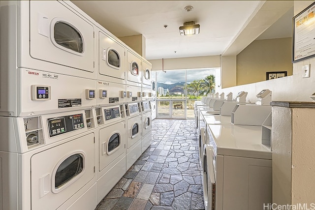 445 Seaside Ave Unit 1618, Honolulu, HI 96815 - shared laundry featuring estacked washer and dryer, washing machine and dryer, and stone tile floors
