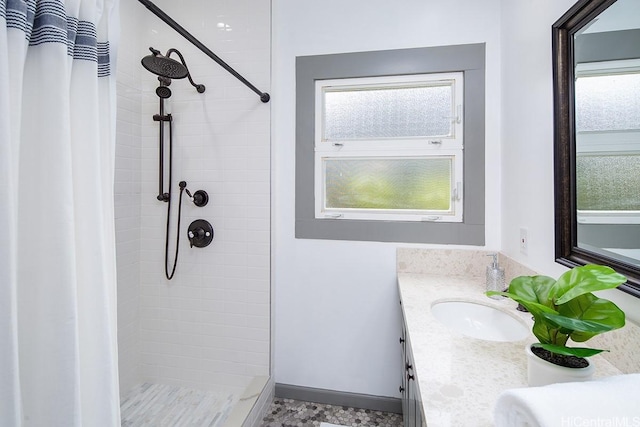 full bathroom with double vanity and a tile shower
