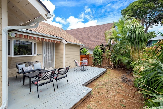 wooden terrace with an outdoor living space