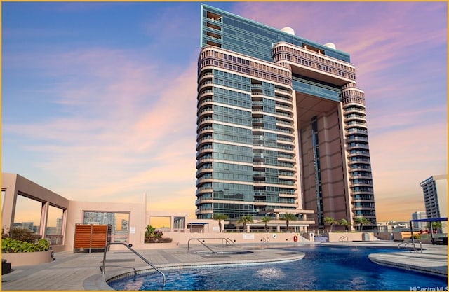 1888 Kalakaua Ave Unit 807, Honolulu, HI 96815 - pool at dusk with a community pool and a patio area