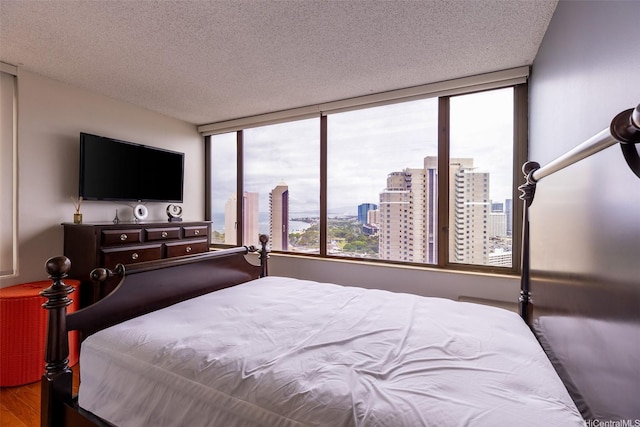 411 Hobron Ln Unit 3314, Honolulu, HI 96815 - bedroom with wood finished floors and a textured ceiling