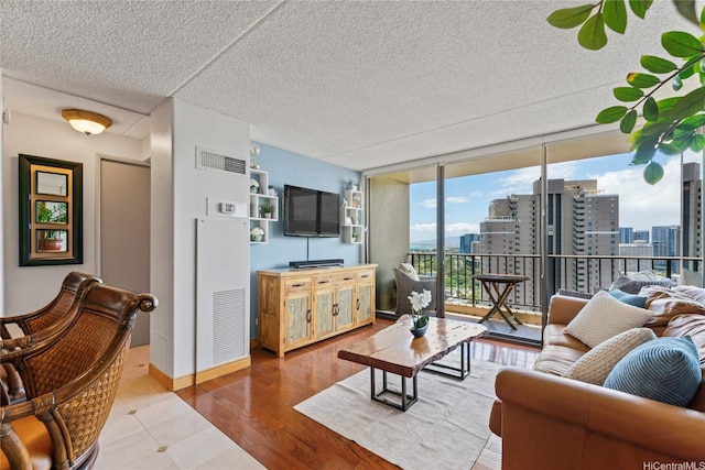 411 Hobron Ln Unit 3314, Honolulu, HI 96815 - living area with a textured ceiling, a wall of windows, and wood finished floors