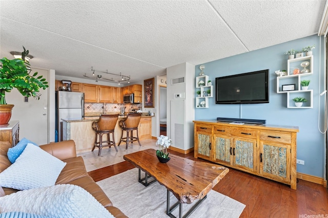 411 Hobron Ln Unit 3314, Honolulu, HI 96815 - living area with a textured ceiling and light wood-type flooring