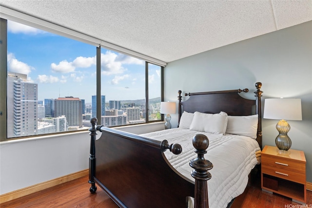 411 Hobron Ln Unit 3314, Honolulu, HI 96815 - bedroom with wood finished floors, a city view, and a textured ceiling