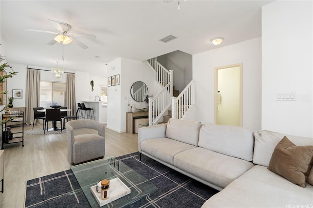 91-1059 Kaimalie St Unit 2P1, Ewa Beach, HI 96706 - living area featuring a ceiling fan, stairway, light wood-style floors, and a chandelier