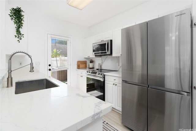 91-1059 Kaimalie St Unit 2P1, Ewa Beach, HI 96706 - kitchen featuring stainless steel appliances, white cabinetry, and light stone counters