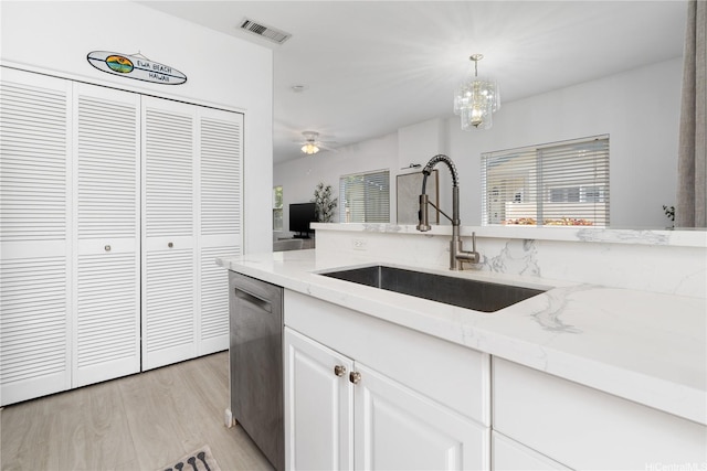 91-1059 Kaimalie St Unit 2P1, Ewa Beach, HI 96706 - kitchen featuring dishwasher, light stone counters, light wood-style floors, white cabinets, and hanging light fixtures