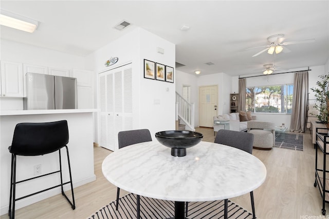 91-1059 Kaimalie St Unit 2P1, Ewa Beach, HI 96706 - dining space featuring stairway, light wood finished floors, and a ceiling fan