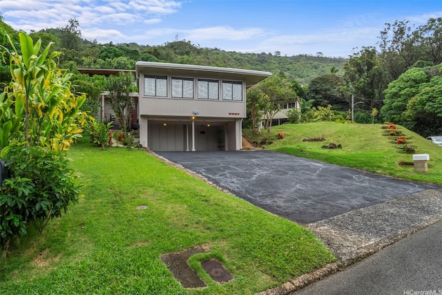 3657 Woodlawn Dr, Honolulu, HI 96822 - view of front of home featuring asphalt driveway, a front lawn, and a garage
