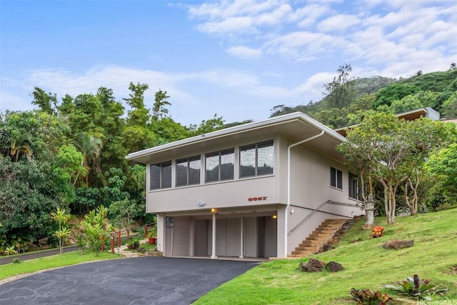 3657 Woodlawn Dr, Honolulu, HI 96822 - view of front of home featuring an attached garage, driveway, stairway, and a front lawn