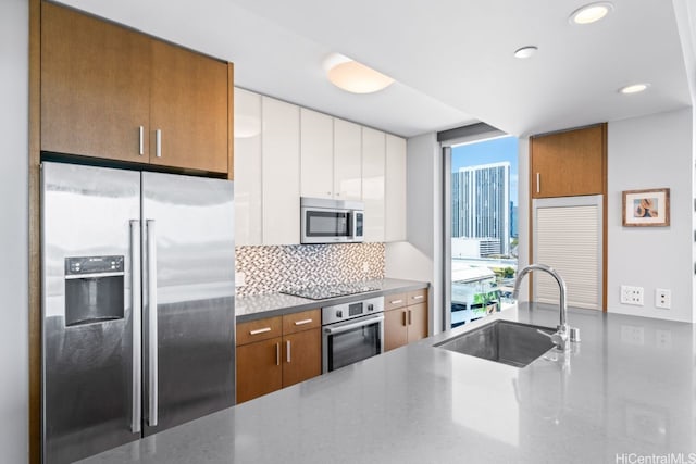 600 Ala Moana Blvd Unit 1101, Honolulu, HI 96813 - kitchen featuring stainless steel appliances, a sink, tasteful backsplash, recessed lighting, and brown cabinetry