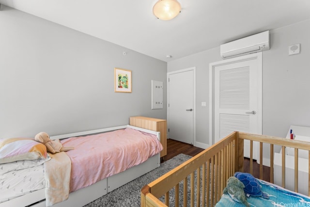 600 Ala Moana Blvd Unit 1101, Honolulu, HI 96813 - bedroom featuring a wall mounted AC, wood finished floors, and a closet