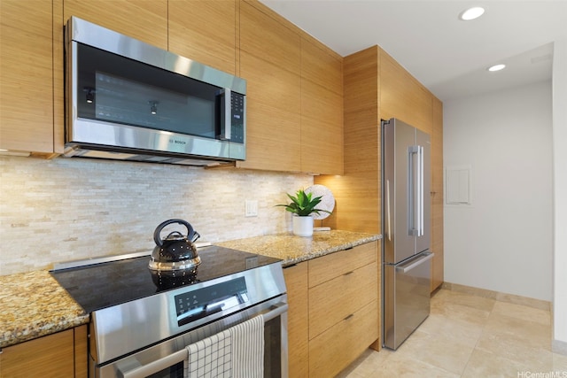 389D Kaelepulu Dr Unit 1504, Kailua, HI 96734 - kitchen with stainless steel appliances, tasteful backsplash, light stone countertops, baseboards, and light tile patterned floors