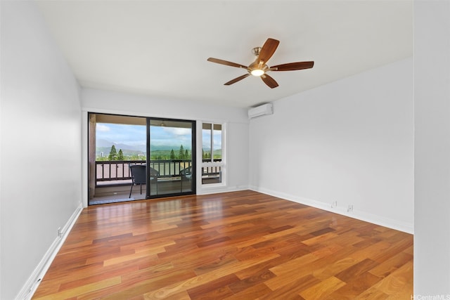 389D Kaelepulu Dr Unit 1504, Kailua, HI 96734 - spare room featuring a ceiling fan, wood finished floors, baseboards, and a wall mounted air conditioner