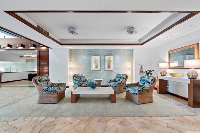 343 Hobron Ln Unit L103, Honolulu, HI 96815 - living area featuring stone finish floors, a raised ceiling, and plenty of natural light