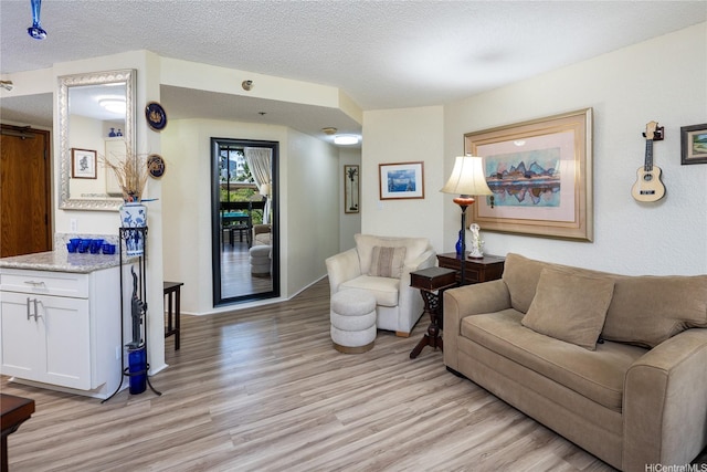 300 Wai Nani Way Unit I304, Honolulu, HI 96815 - living area with light wood-style floors and a textured ceiling