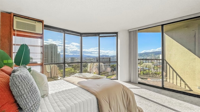60 N Beretania St Unit 1702, Honolulu, HI 96817 - bedroom with a wall of windows, a wall unit AC, a city view, access to exterior, and carpet flooring