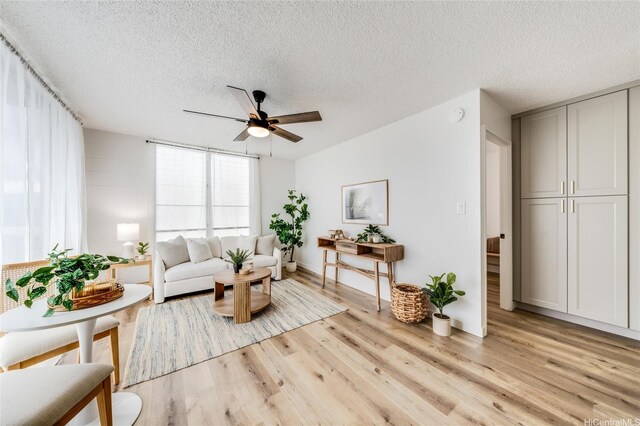 906 Lehua Ave Unit C301, Pearl City, HI 96782 - living room featuring a textured ceiling, light wood finished floors, and ceiling fan