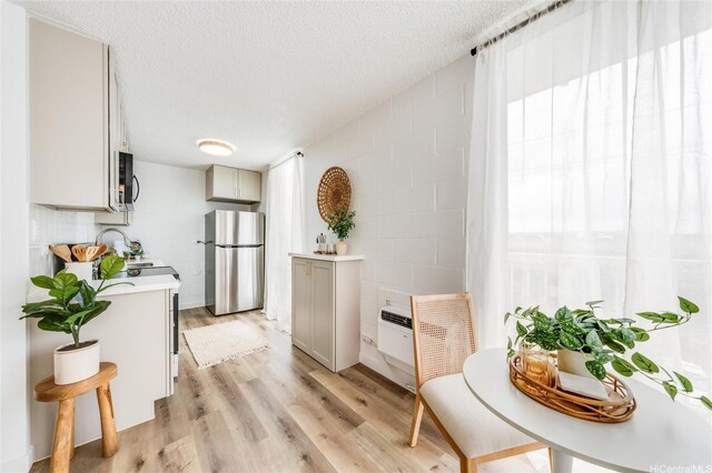 906 Lehua Ave Unit C301, Pearl City, HI 96782 - kitchen with appliances with stainless steel finishes, light countertops, light wood-style flooring, plenty of natural light, and a textured ceiling