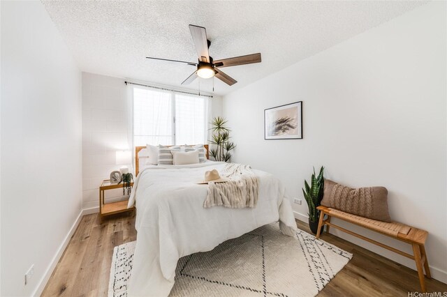 906 Lehua Ave Unit C301, Pearl City, HI 96782 - bedroom featuring light wood-style floors, baseboards, a ceiling fan, and a textured ceiling