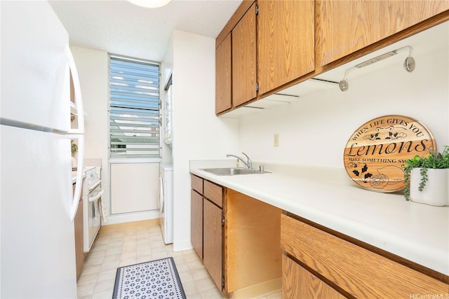 1122 Elm St Unit 809, Honolulu, HI 96814 - kitchen with freestanding refrigerator, light countertops, range, and brown cabinets