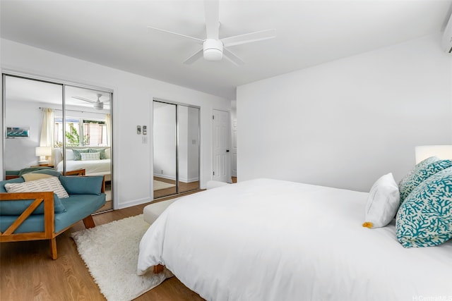 464 Poipu Dr, Honolulu, HI 96825 - bedroom with multiple closets, wood finished floors, ceiling fan, and a wall unit AC
