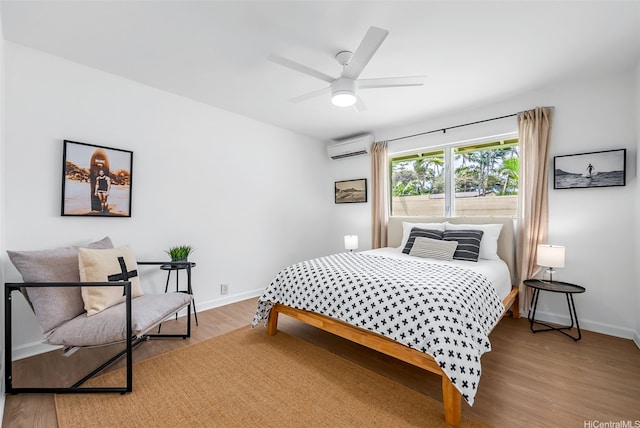 464 Poipu Dr, Honolulu, HI 96825 - bedroom with an AC wall unit, wood finished floors, baseboards, and a ceiling fan