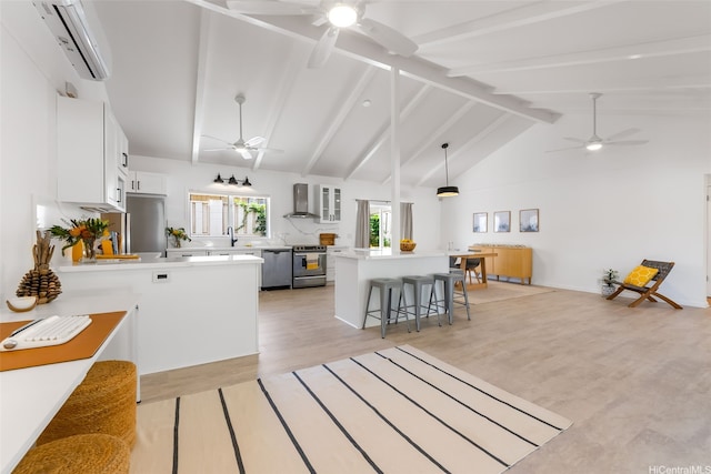 464 Poipu Dr, Honolulu, HI 96825 - kitchen featuring ceiling fan, appliances with stainless steel finishes, a breakfast bar area, wall chimney exhaust hood, and a wall unit AC