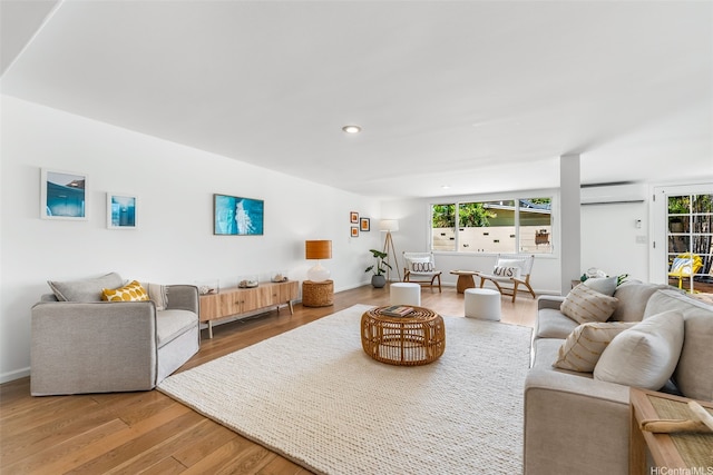 464 Poipu Dr, Honolulu, HI 96825 - living area with wood finished floors, an AC wall unit, recessed lighting, and baseboards