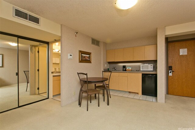 1088 Bishop St Unit 2201, Honolulu, HI 96813 - kitchen with dishwasher, light colored carpet, white microwave, light brown cabinets, and a textured ceiling