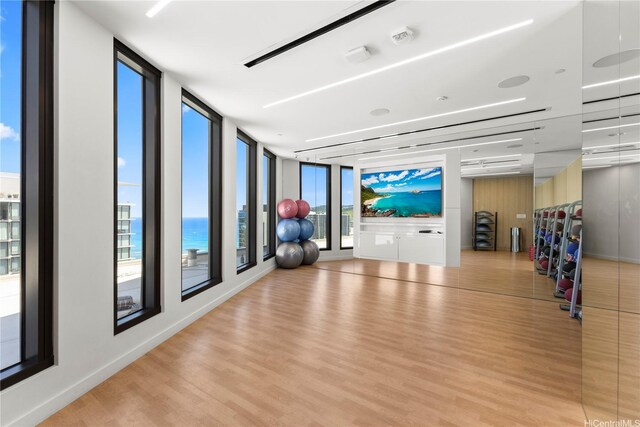 987 Queen St Unit 1615, Honolulu, HI 96814 - exercise room featuring wood finished floors, floor to ceiling windows, and a water view