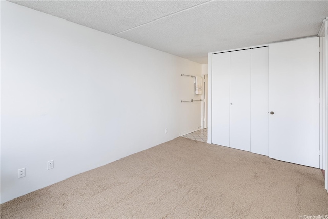400 Hobron Ln Unit 2412, Honolulu, HI 96815 - unfurnished bedroom with light colored carpet, a closet, and a textured ceiling