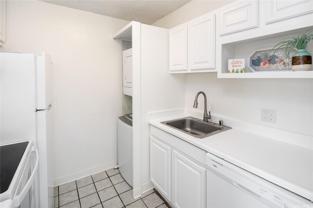 400 Hobron Ln Unit 2412, Honolulu, HI 96815 - kitchen featuring estacked washer and dryer, white dishwasher, range with electric stovetop, white cabinets, and light tile patterned floors