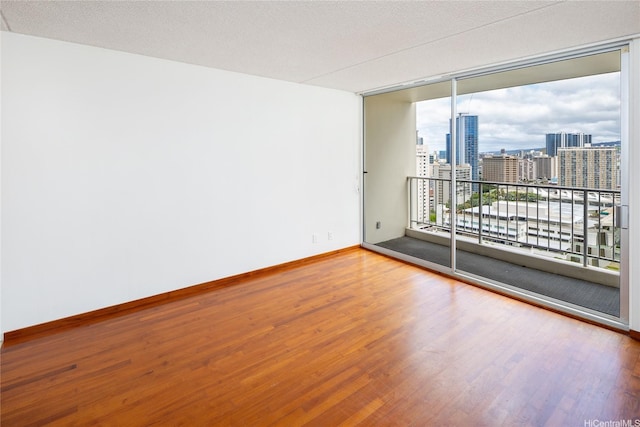 400 Hobron Ln Unit 2412, Honolulu, HI 96815 - empty room with wood finished floors and a city view