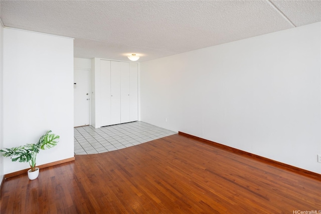 400 Hobron Ln Unit 2412, Honolulu, HI 96815 - unfurnished room featuring wood finished floors and a textured ceiling
