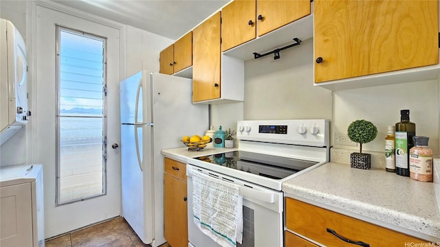 99-015 Kalaloa St Unit 807, Aiea, HI 96701 - kitchen with white appliances, light countertops, and brown cabinets