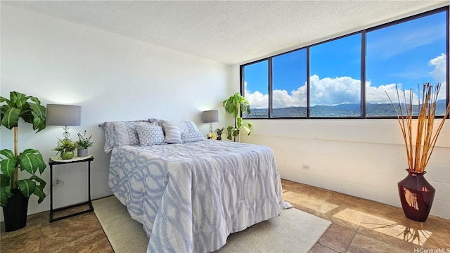 99-015 Kalaloa St Unit 807, Aiea, HI 96701 - bedroom with a textured ceiling and stone finish flooring