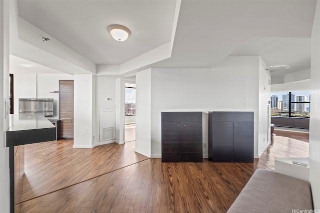 1221 Victoria St Unit 1705, Honolulu, HI 96814 - unfurnished living room with plenty of natural light, wood finished floors, and baseboards