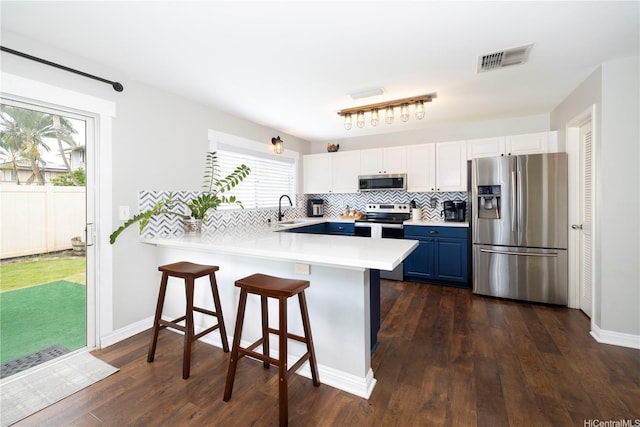 91-1013 Kailike St, Ewa Beach, HI 96706 - kitchen with appliances with stainless steel finishes, blue cabinetry, light countertops, a breakfast bar, and a peninsula