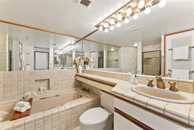 1525 Wilder Ave Unit 903, Honolulu, HI 96822 - bathroom featuring a bath, vanity, tiled shower, and toilet