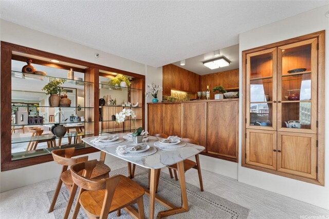 1525 Wilder Ave Unit 903, Honolulu, HI 96822 - dining room featuring light colored carpet and a textured ceiling