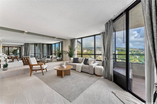 1525 Wilder Ave Unit 903, Honolulu, HI 96822 - carpeted living room featuring a wall of windows, a textured ceiling, and healthy amount of natural light
