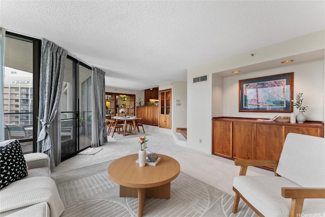 1525 Wilder Ave Unit 903, Honolulu, HI 96822 - living room featuring light colored carpet, a textured ceiling, and floor to ceiling windows