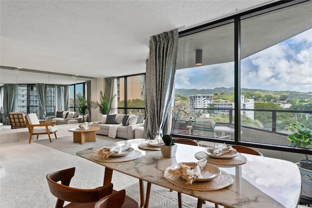 1525 Wilder Ave Unit 903, Honolulu, HI 96822 - living room with a wall of windows, plenty of natural light, a textured ceiling, and carpet floors