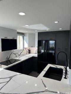 98-99 Uao Pl Unit 1710, Aiea, HI 96701 - kitchen featuring freestanding refrigerator, modern cabinets, light stone counters, recessed lighting, and white cabinetry