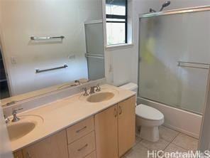 95-233 Halepule Pl Unit 44, Honolulu, HI 96789 - bathroom featuring double vanity, toilet, enclosed tub / shower combo, and tile patterned flooring