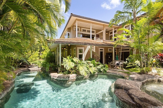 876 Aalapapa Dr Unit B, Kailua, HI 96734 - rear view of house with stairs, stucco siding, and a small pond