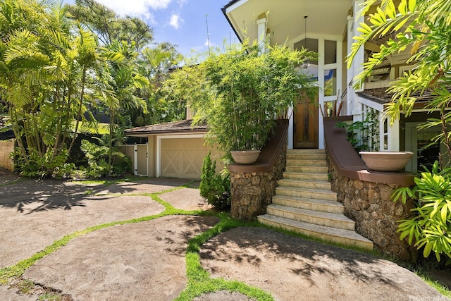 876 Aalapapa Dr Unit B, Kailua, HI 96734 - view of front of house featuring a garage, driveway, and stucco siding